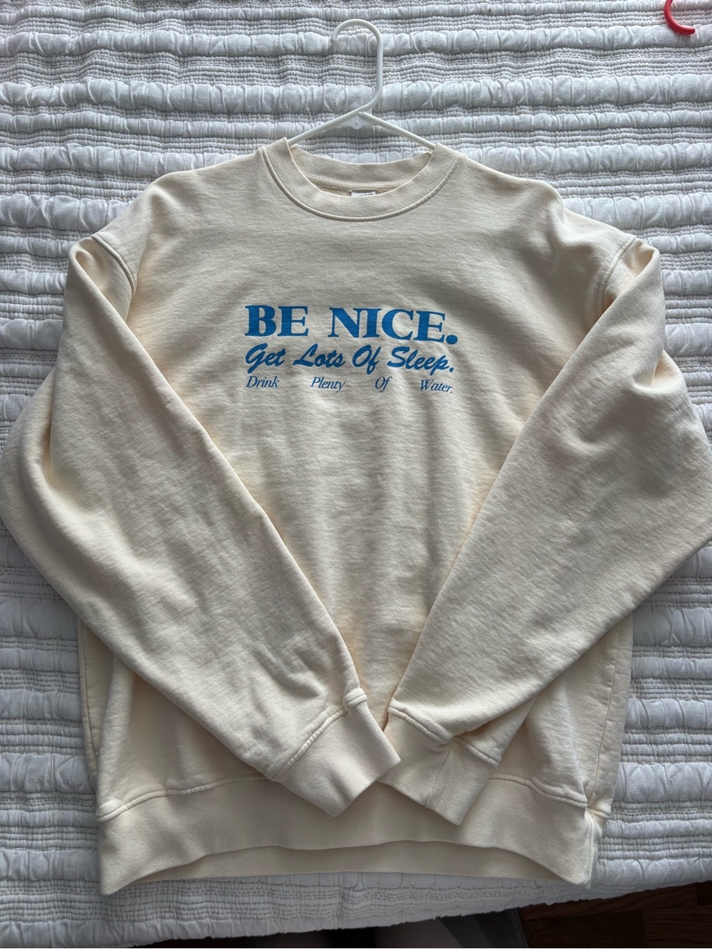 Sporty & Rich Cream Crewneck with Blue "BE NICE." Graphic